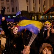 People gather outside the presidential office in Kyiv on Dec. 9, 2019, as they wait for news of talks held in Paris to try to end the conflict in eastern Ukraine.